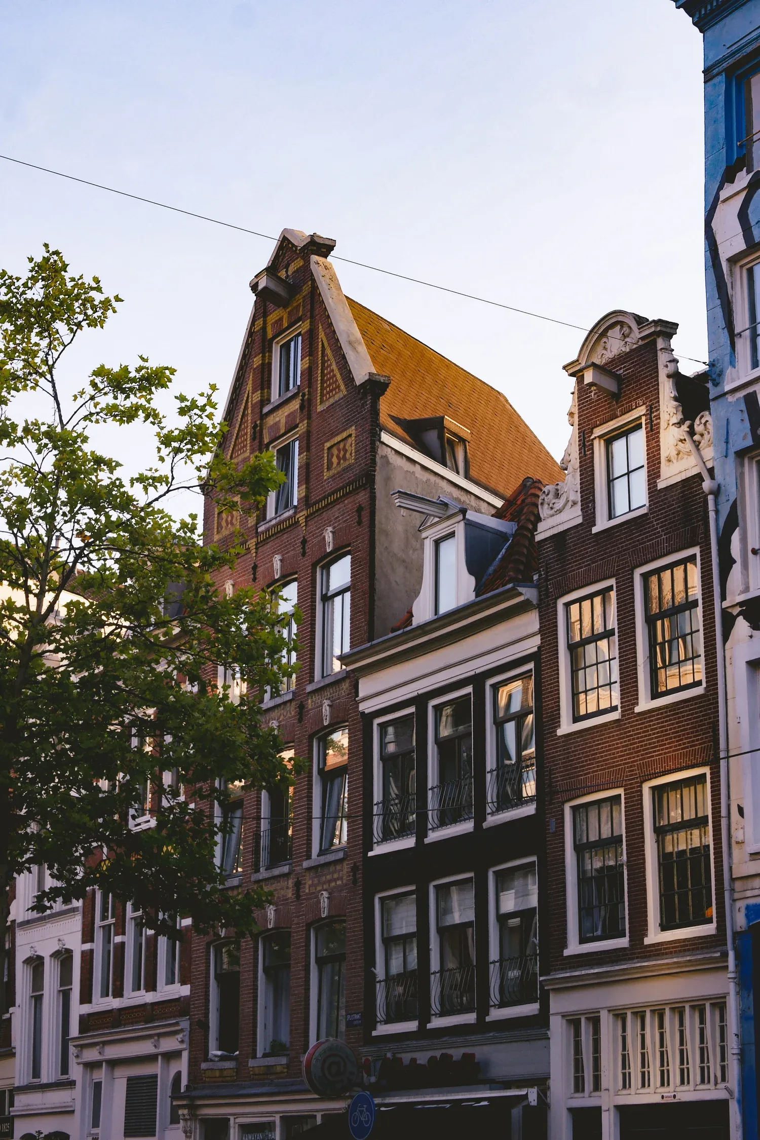 Amsterdamse grachtenpanden bij avondschemering — woningaanbod Nieuw Amsterdams Huys